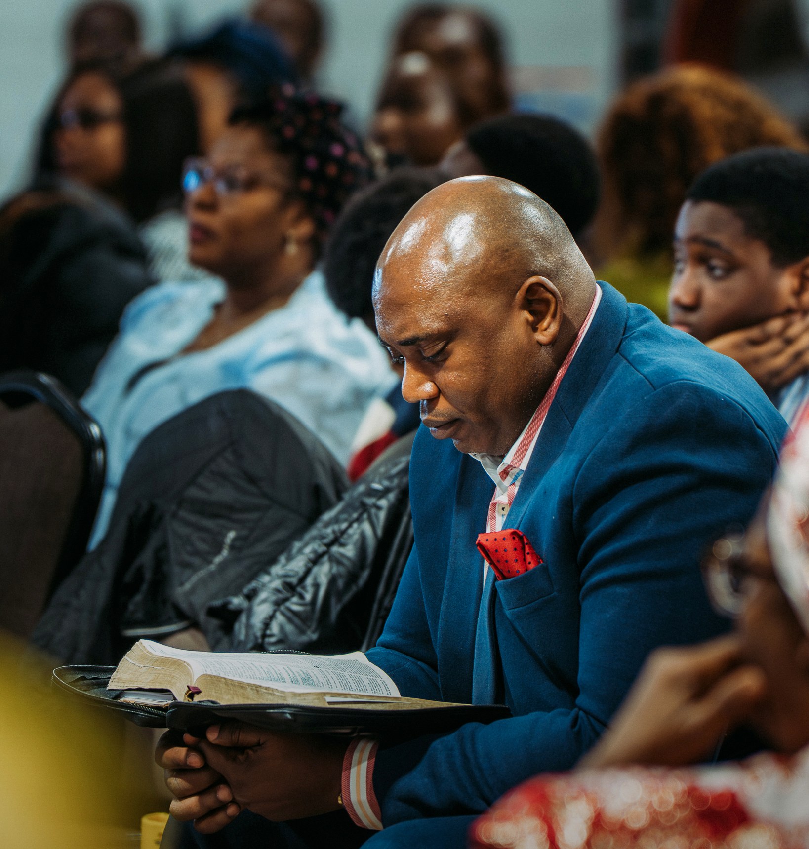 A church member seated among others at the gathering