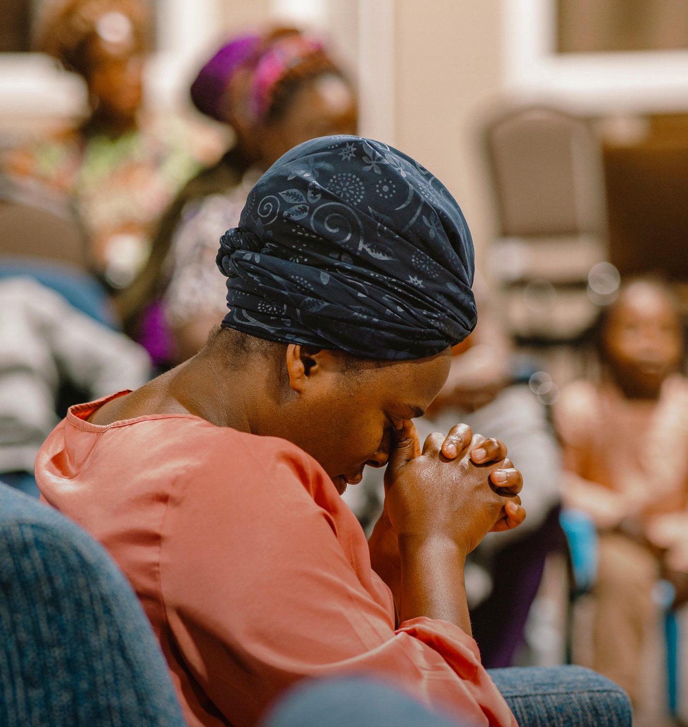 A church member deep in prayer during Destiny Recovery