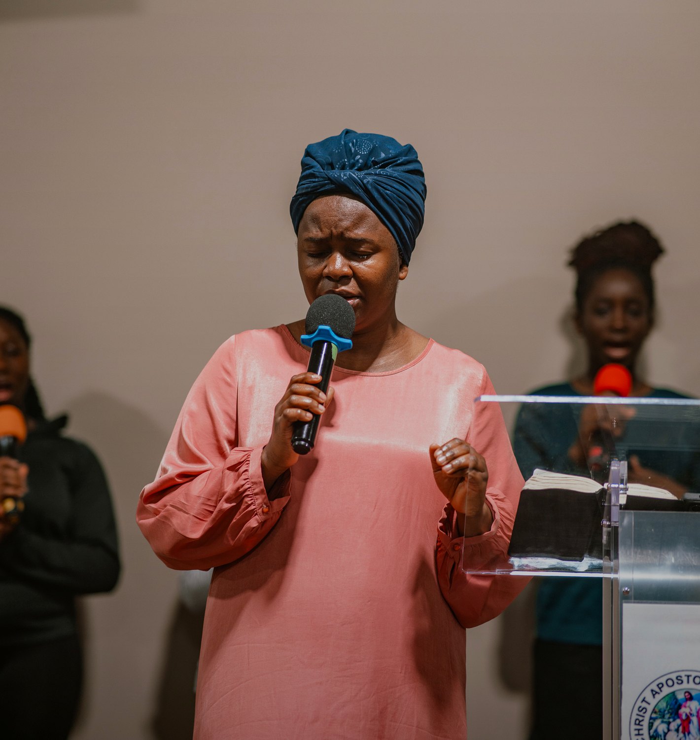 A woman leading a prayer song