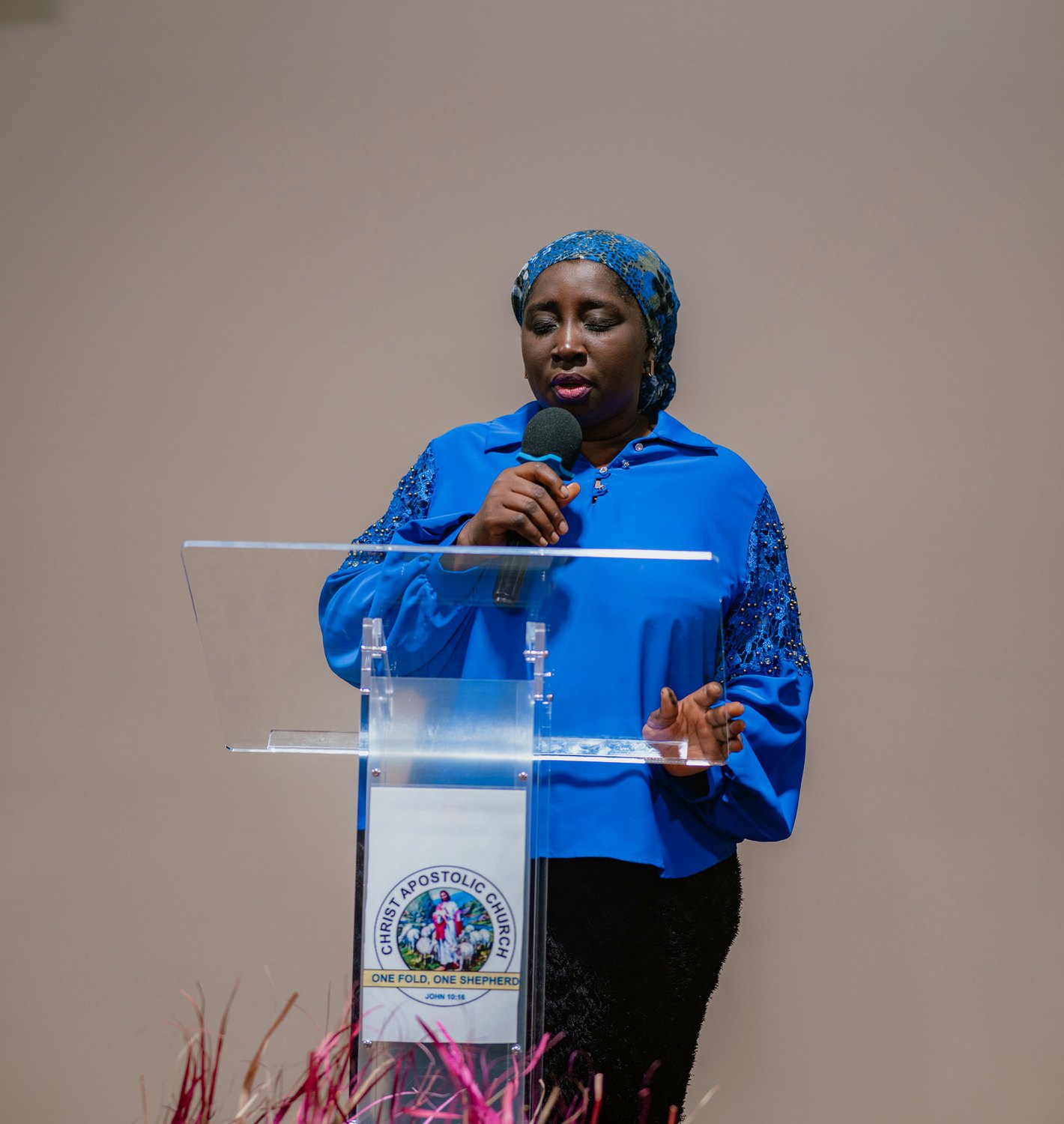 A woman praying at the pulpit