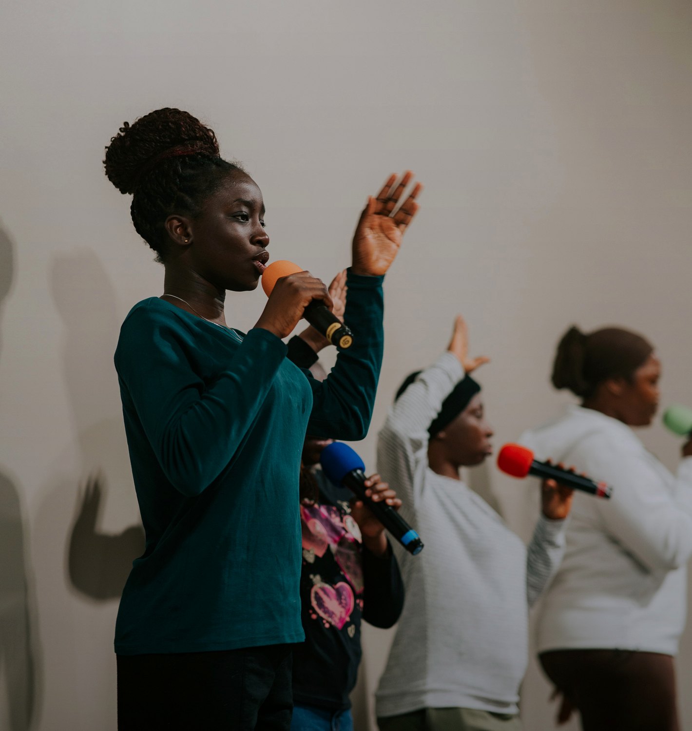 A worship leader singing with the team