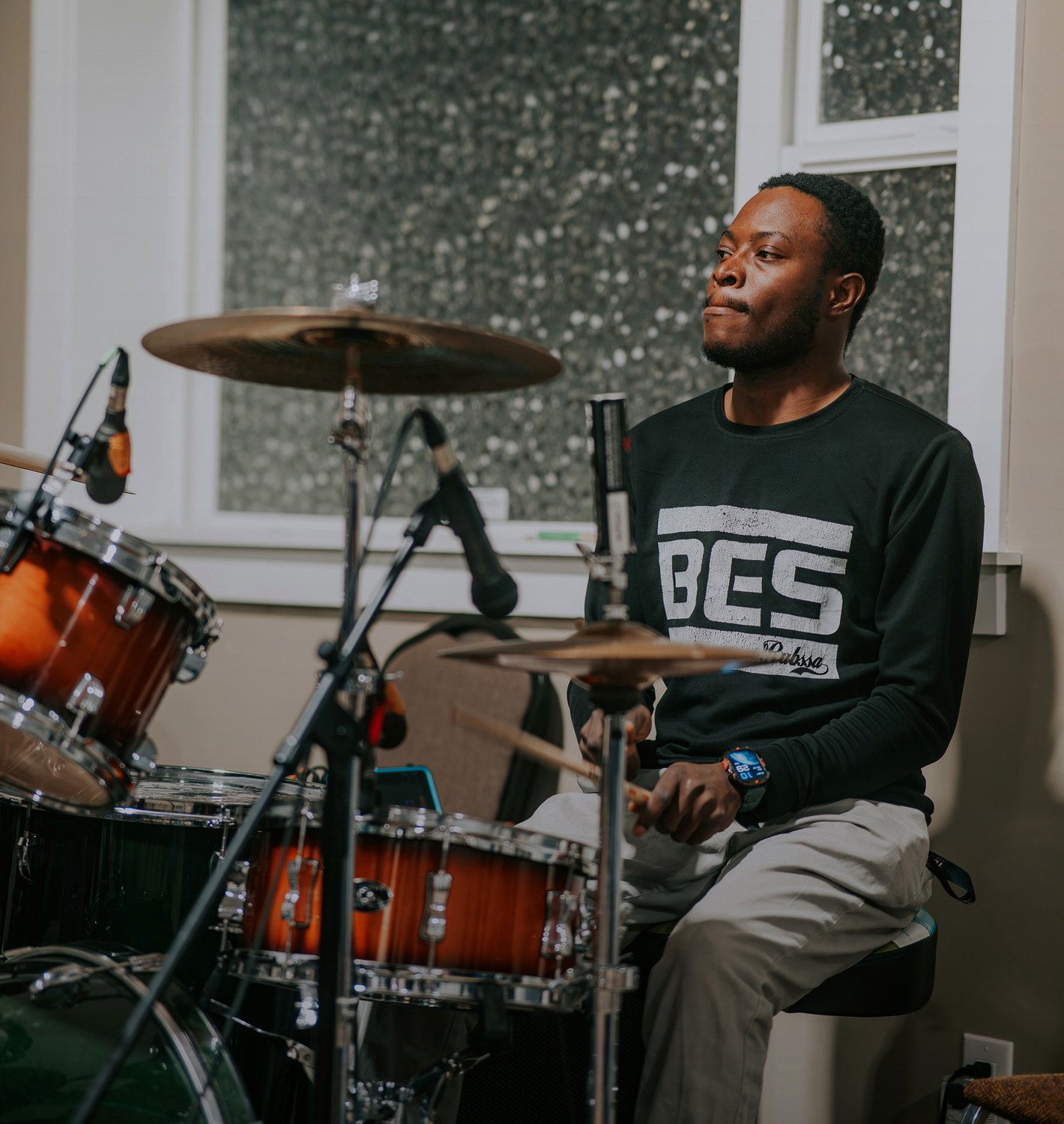 The drummer playing during worship
