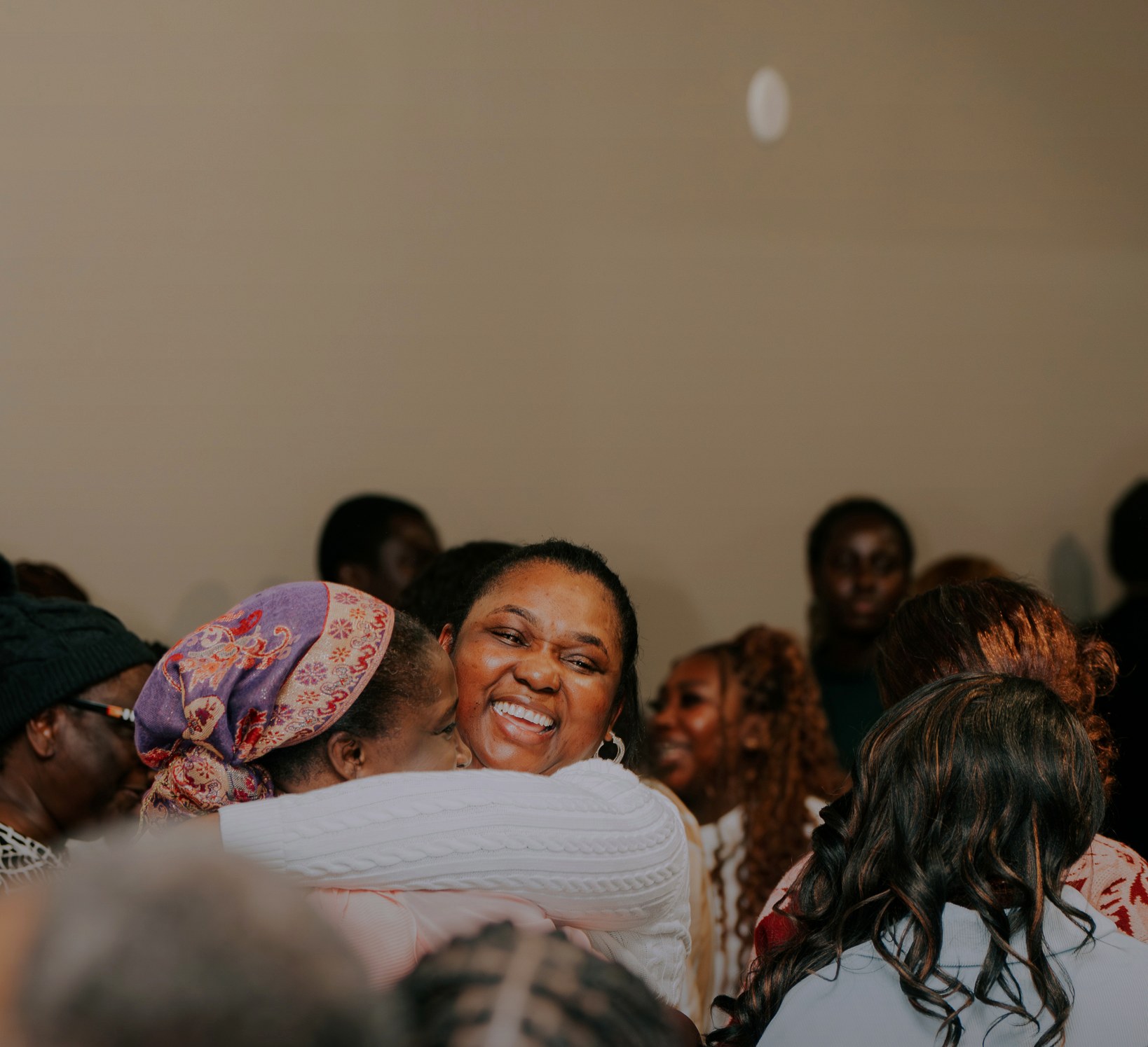 Church members gathered in an embrace
