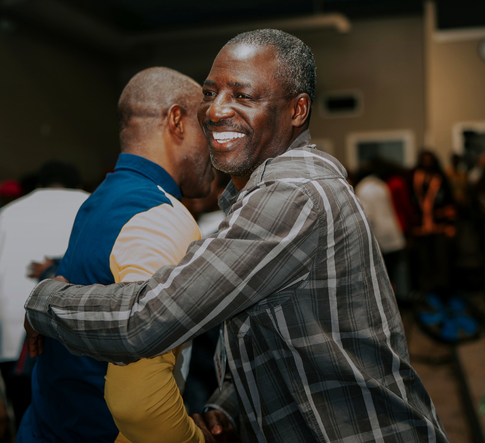 Two church members sharing a brotherly hug