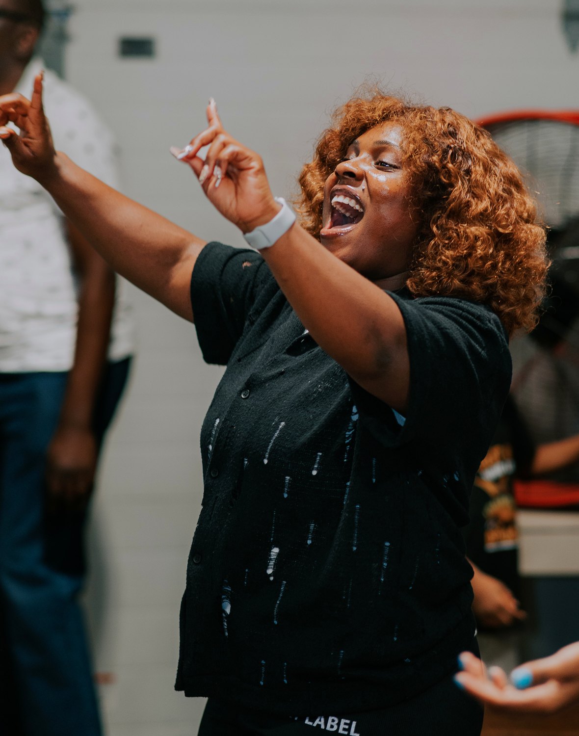 A worship moment with hands lifted during Solution Hour