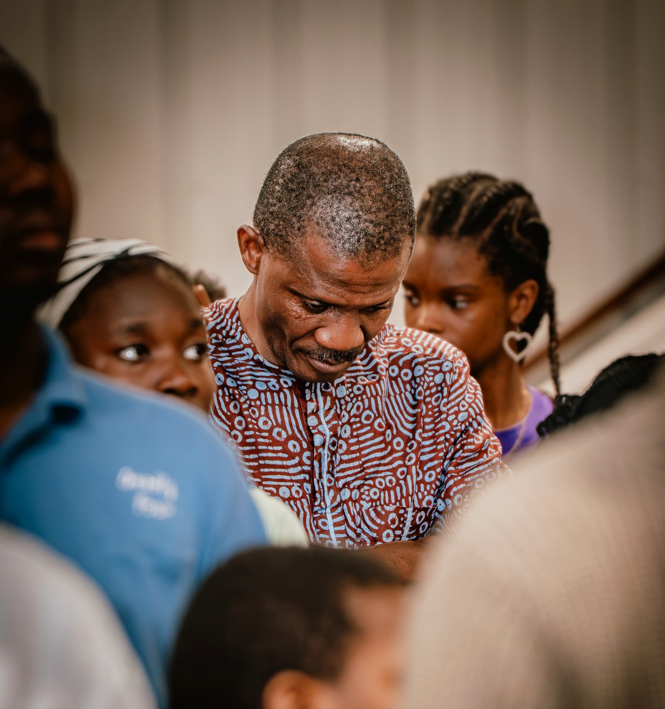 A family prayer moment during Solution Hour